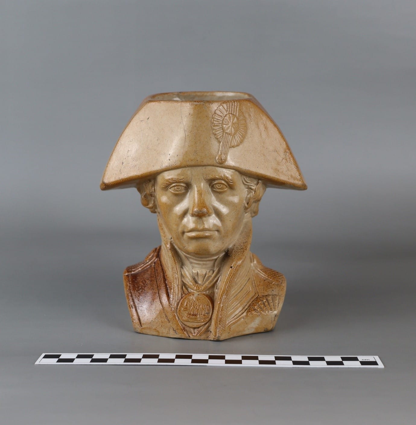 A statue of a person in a hat

Description automatically generated